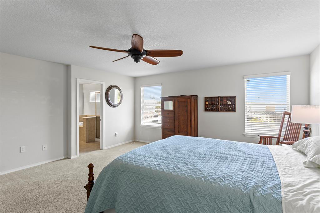 2839 Maple Brook Loop Lutz, FL 33558 - Photo 29 of 61 a bedroom with a large bed and a large window