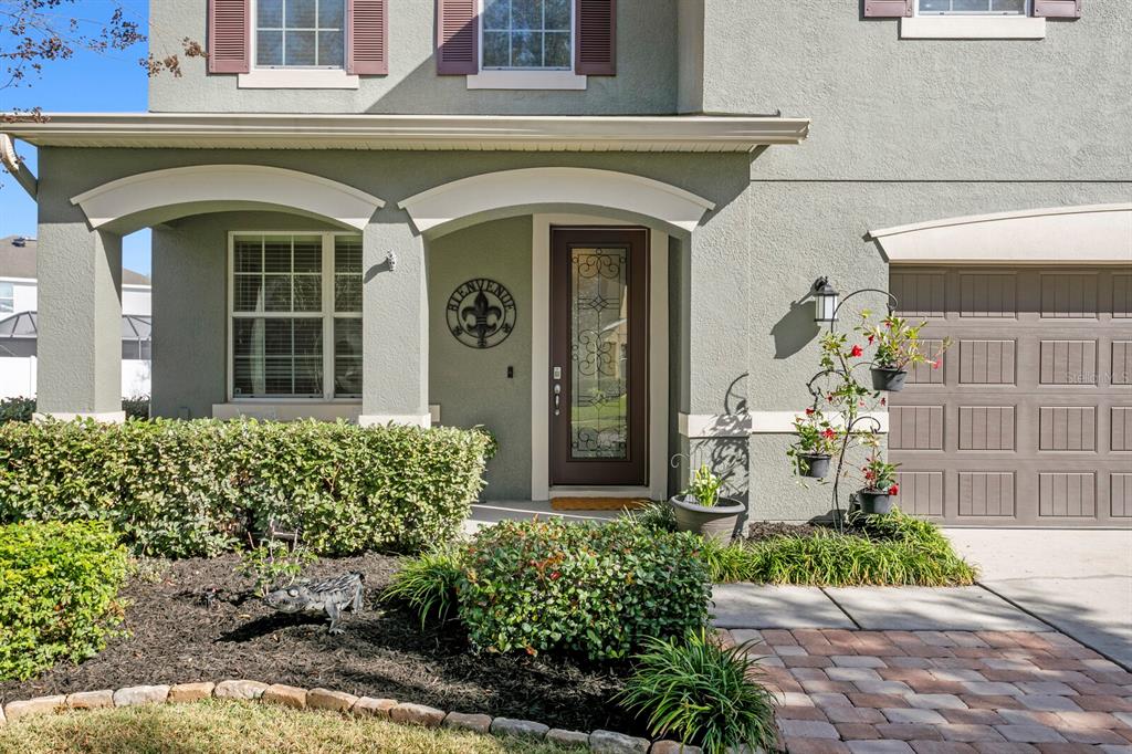 2839 Maple Brook Loop Lutz, FL 33558 - Photo 3 of 61 a front view of a house with garden