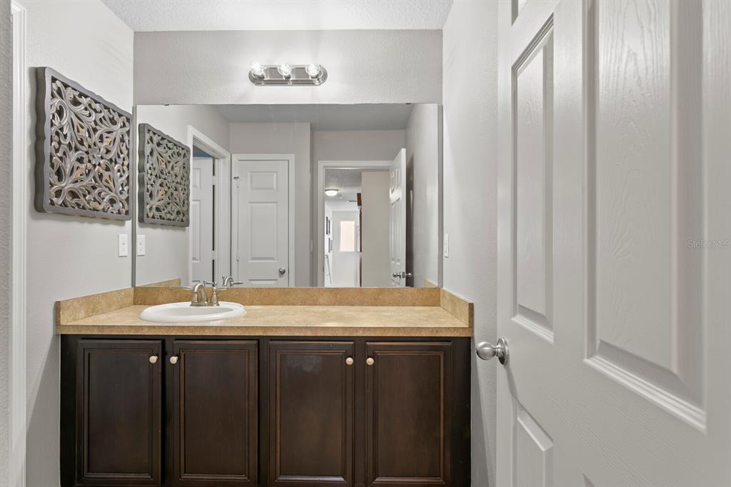 2839 Maple Brook Loop Lutz, FL 33558 - Photo 36 of 61 a bathroom with a granite countertop sink and a mirror