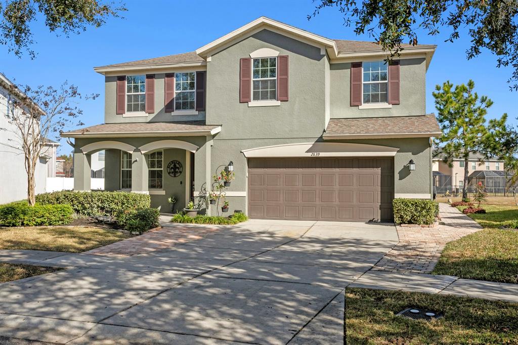 2839 Maple Brook Loop Lutz, FL 33558 - Photo 61 of 61 a front view of a house with a yard and garage