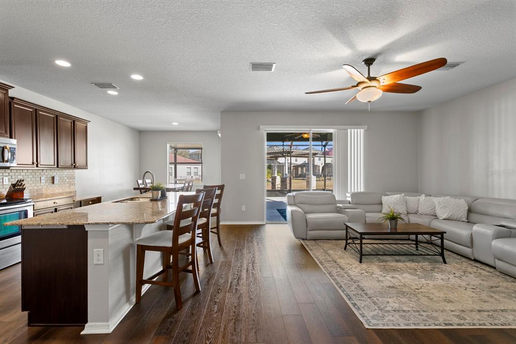 2839 Maple Brook Loop Lutz, FL 33558 - Photo 7 of 61 a living room with furniture a rug and a window
