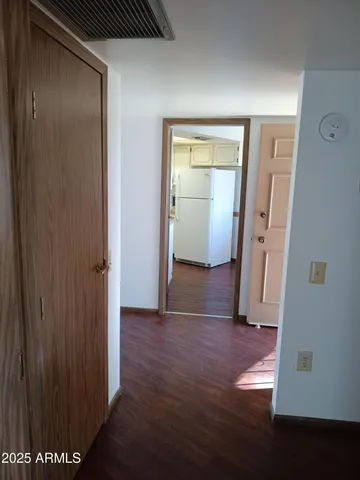 a view of a hallway with wooden floor