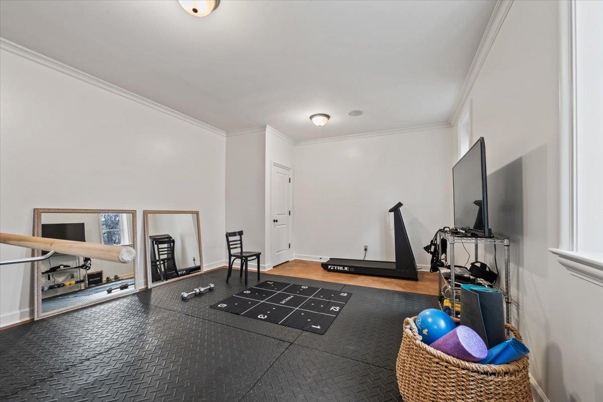 4565 Normandy Road Memphis, TN 38117 - Photo 23 of 40 a living room with furniture gym equipment and a flat screen tv