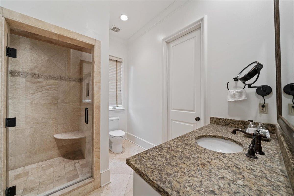 4565 Normandy Road Memphis, TN 38117 - Photo 26 of 40 a bathroom with a granite countertop sink a toilet and shower