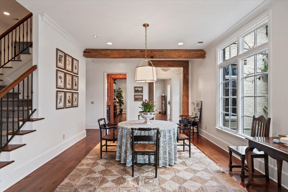 4565 Normandy Road Memphis, TN 38117 - Photo 10 of 40 a dining room with wooden floor and a chandelier