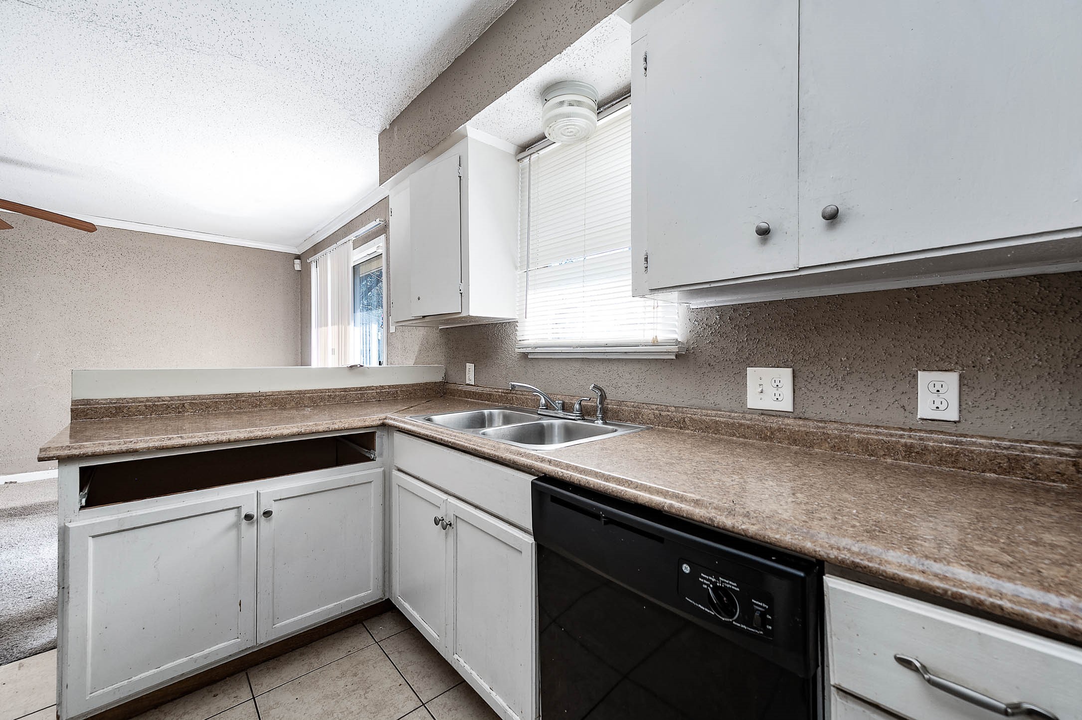 6110 Guadalupe Street Houston, TX 77016 - Photo 10 of 24 a kitchen with granite countertop white cabinets and white appliances