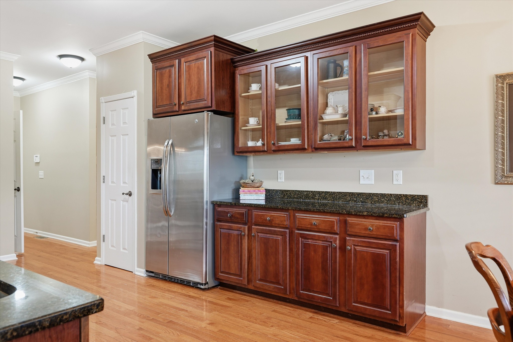 132 Windchase Run Hermitage, TN 37076 - Photo 15 of 38 a kitchen with stainless steel appliances granite countertop a refrigerator and wooden cabinets