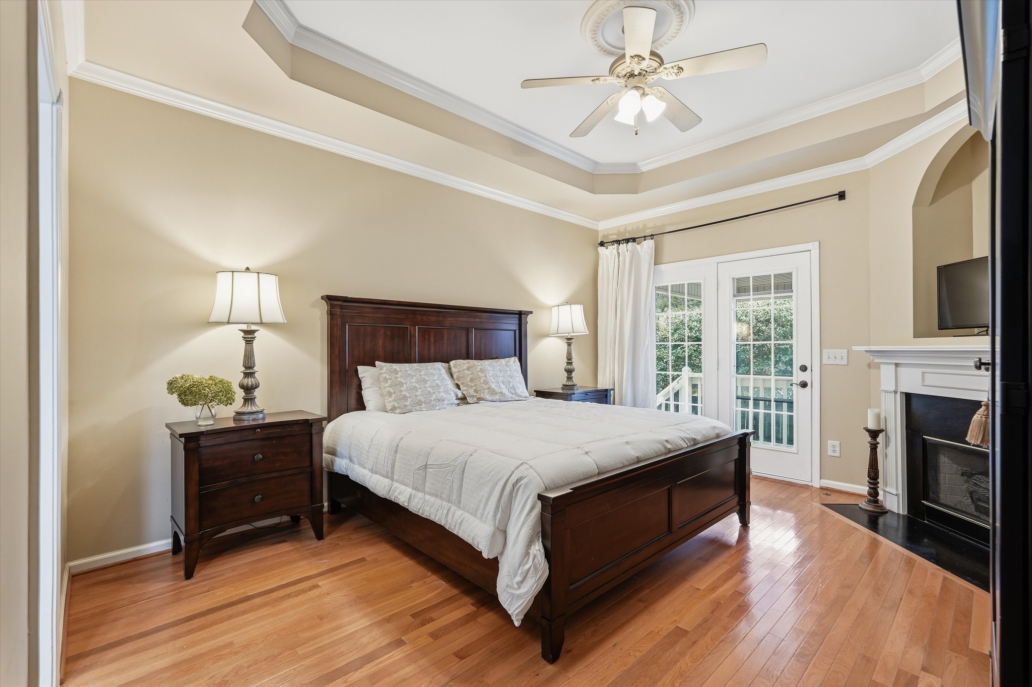 132 Windchase Run Hermitage, TN 37076 - Photo 18 of 38 a bedroom with a bed flat screen tv and a fireplace