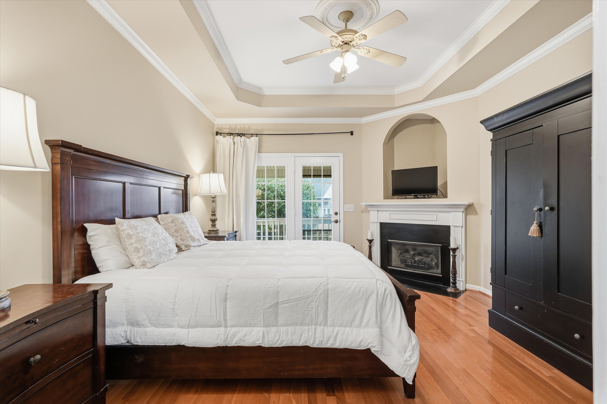 132 Windchase Run Hermitage, TN 37076 - Photo 19 of 38 a bedroom with a large bed and a fireplace