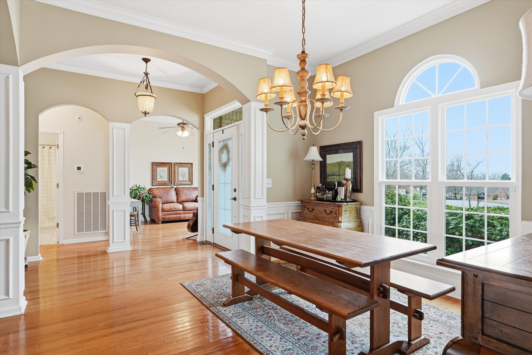 132 Windchase Run Hermitage, TN 37076 - Photo 5 of 38 a large dining room with wooden floor a chandelier a wooden table and chairs