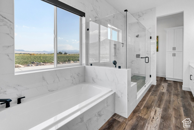 1952 Highway 118 Monroe, UT 84754 - Photo 46 of 88 Bathroom featuring a bath, a marble finish shower, vanity, a mountain view, and wood finished floors