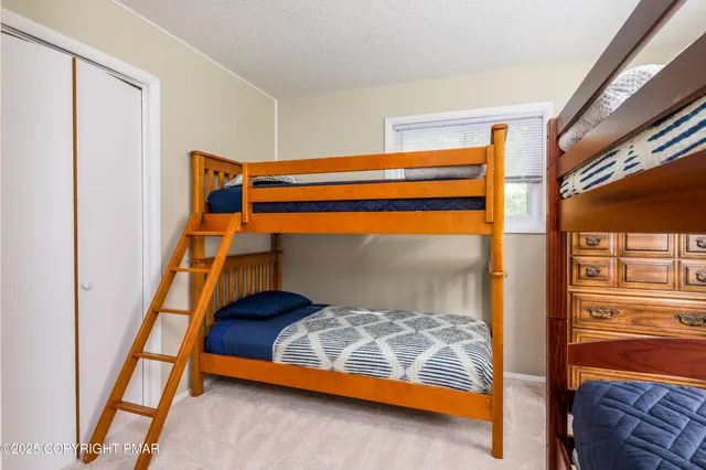 a bedroom with two beds and a lamp on table