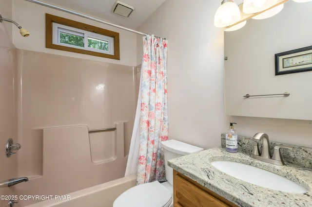 an aerial view of lake residential house with swimming pool and green space