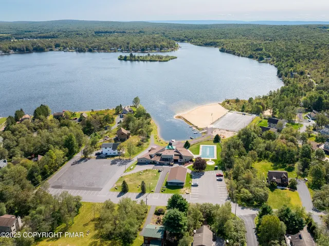 an aerial view of ocean with residential house with outdoor space