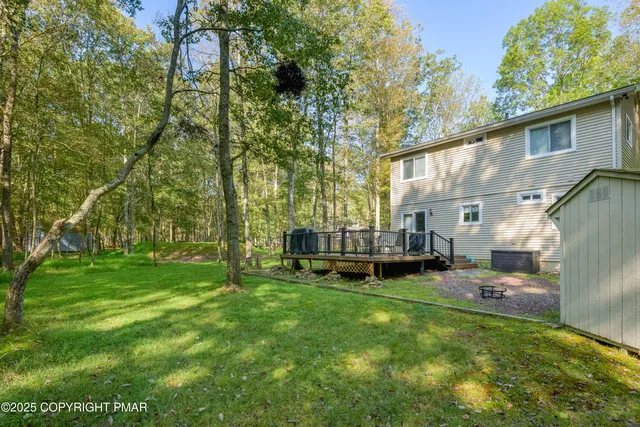 a view of a yard with a house and a bench