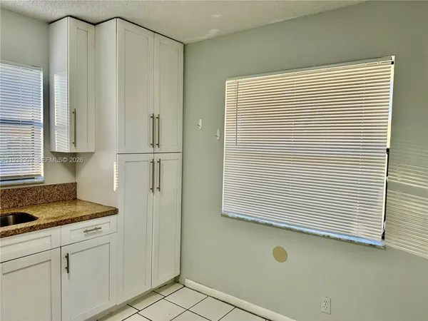 a view of a kitchen cabinets and a window