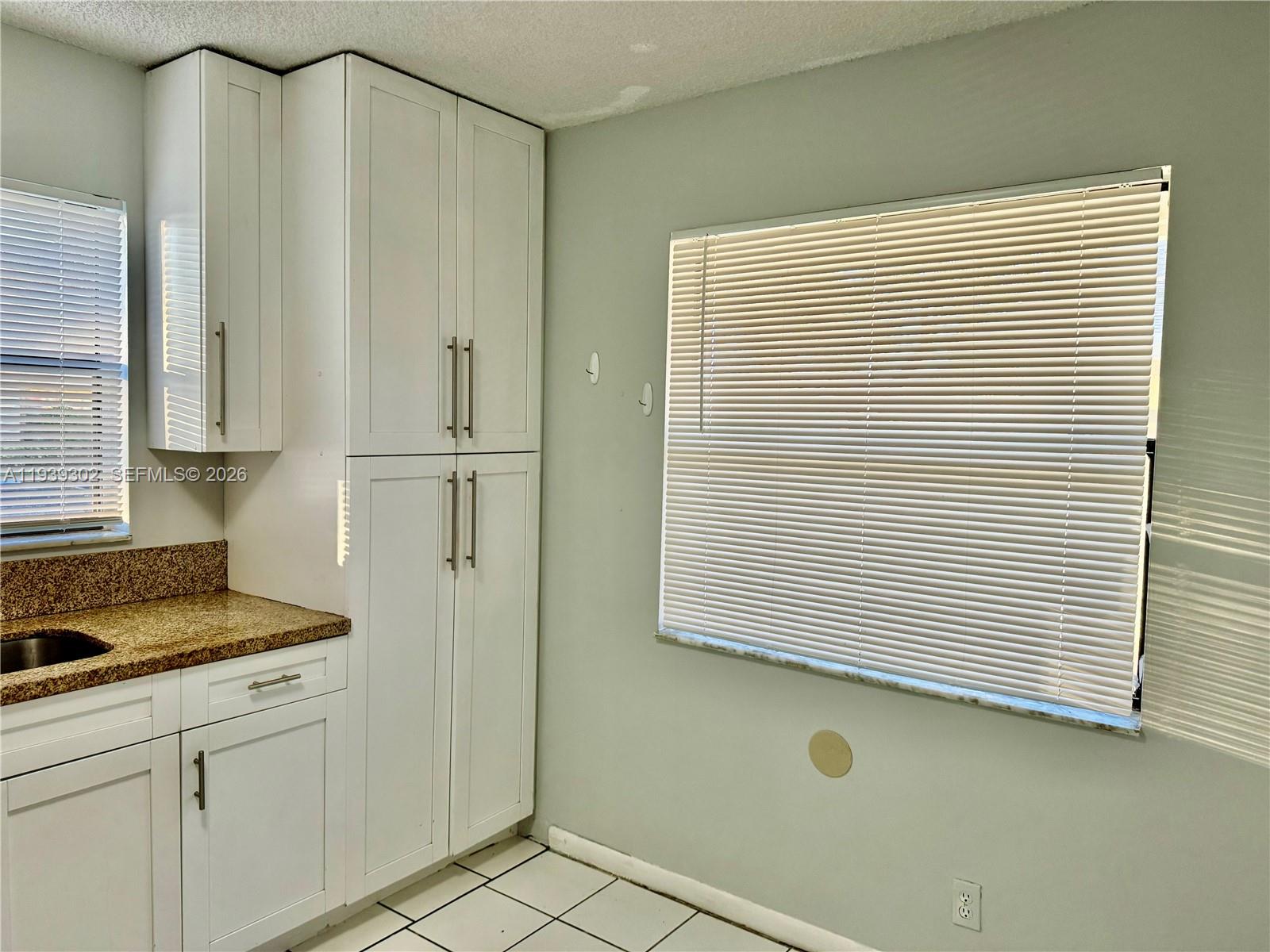 3370 Beau Rivage Drive, Unit 1R Pompano Beach, FL 33064 - Photo 4 of 15 a view of a kitchen cabinets and a window