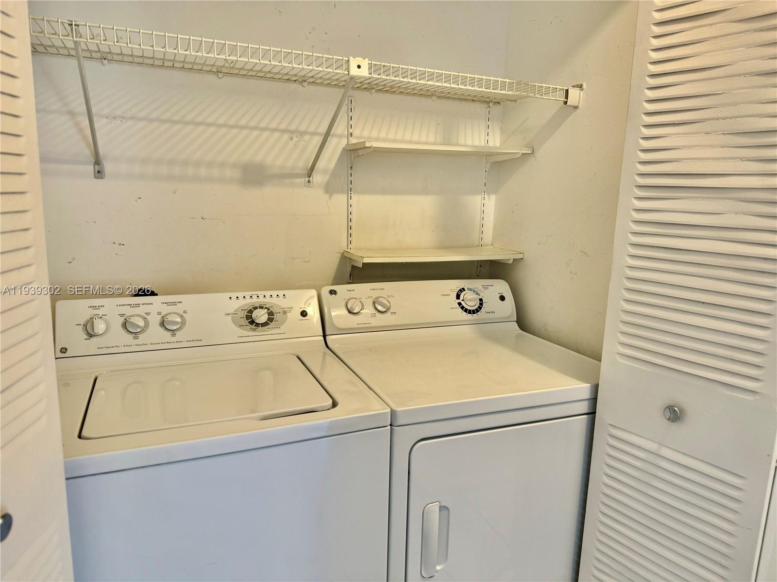 3370 Beau Rivage Drive, Unit 1R Pompano Beach, FL 33064 - Photo 9 of 15 a utility room with dryer and washer