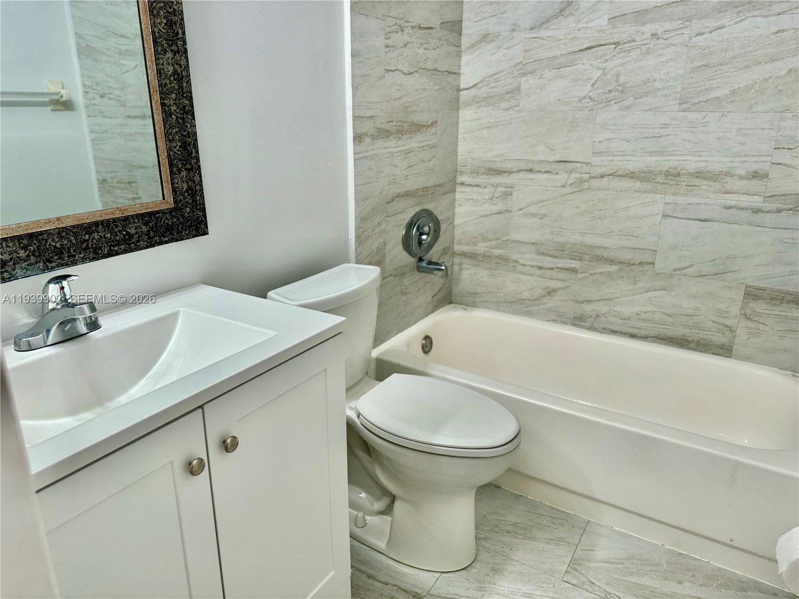 3370 Beau Rivage Drive, Unit 1R Pompano Beach, FL 33064 - Photo 10 of 15 a bathroom with a sink toilet and shower