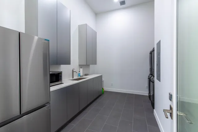 a kitchen with stainless steel appliances a refrigerator and a sink