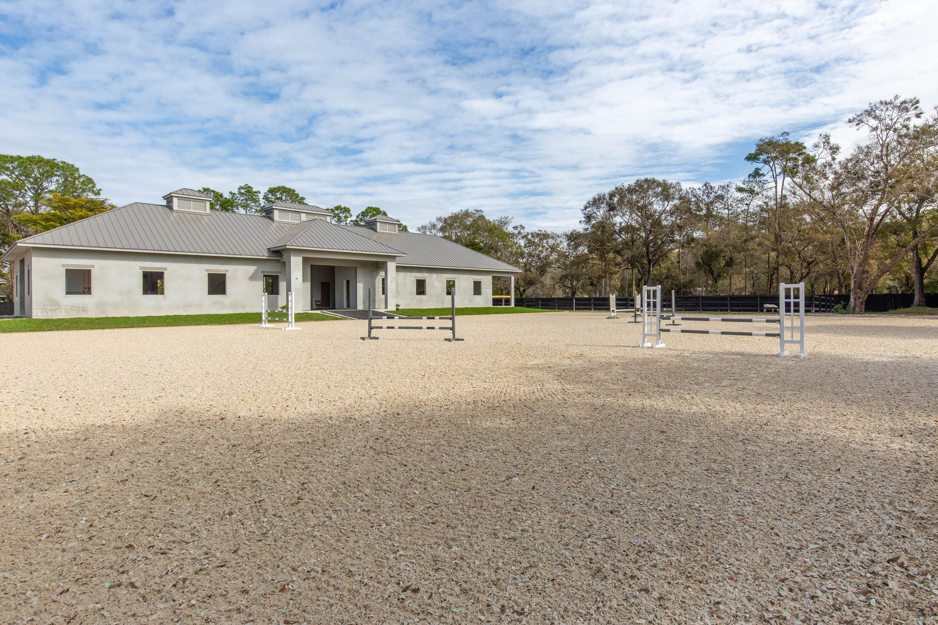 14717 Collecting Canal Road Loxahatchee Groves, FL 33470 - Photo 21 of 27 a front view of a house with a yard and trees