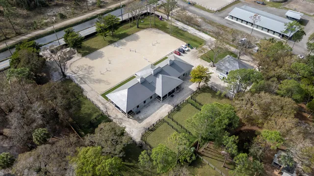 an aerial view of a house with a yard
