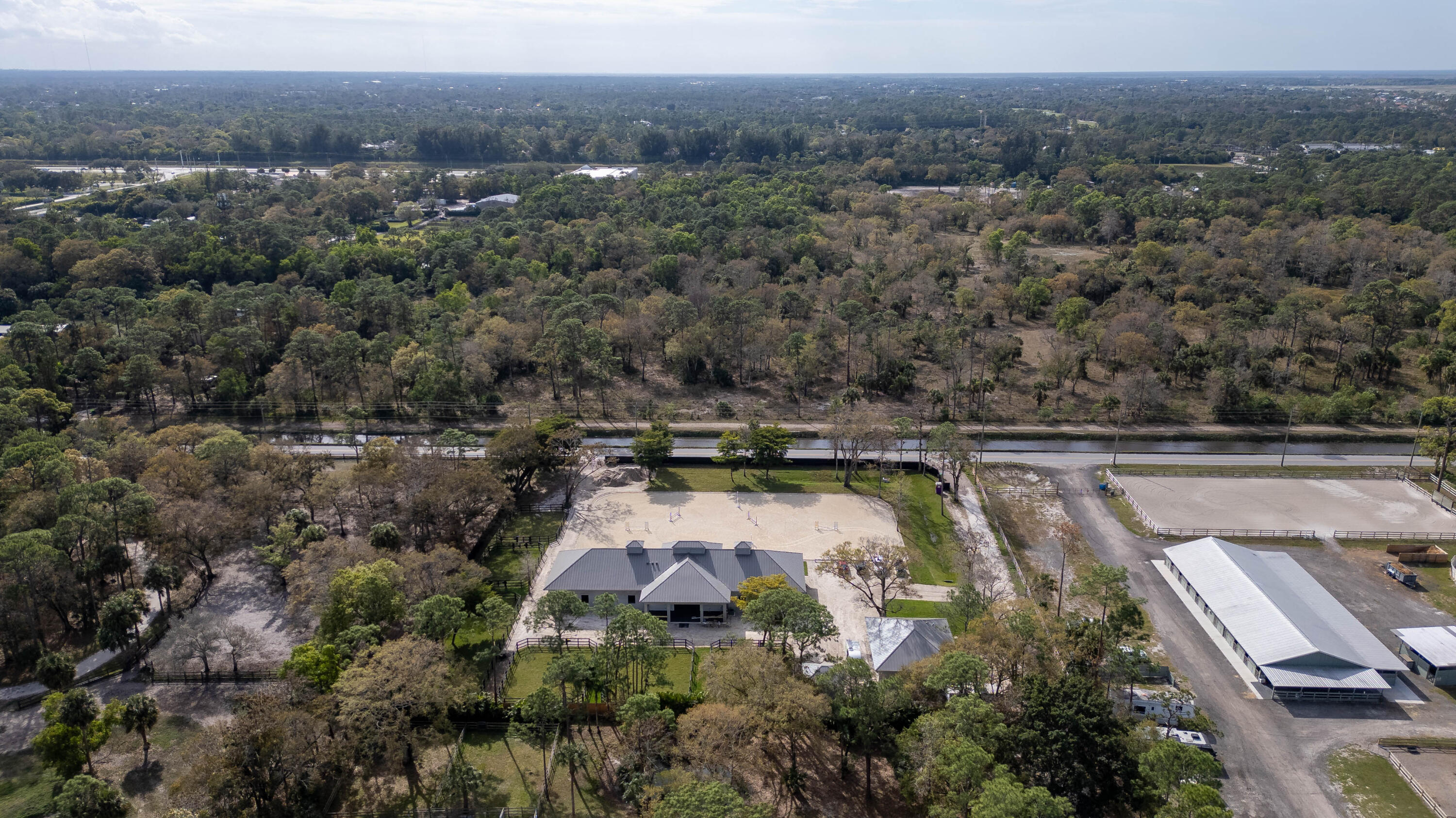 14717 Collecting Canal Road Loxahatchee Groves, FL 33470 - Photo 27 of 27 a view of a swimming pool with a yard