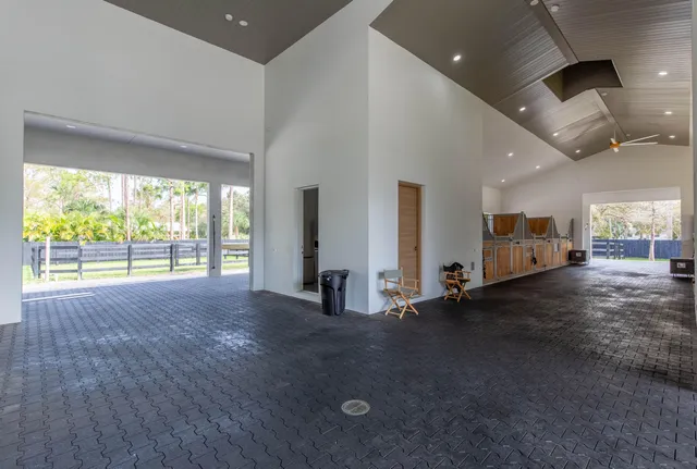 an empty room with fireplace and windows