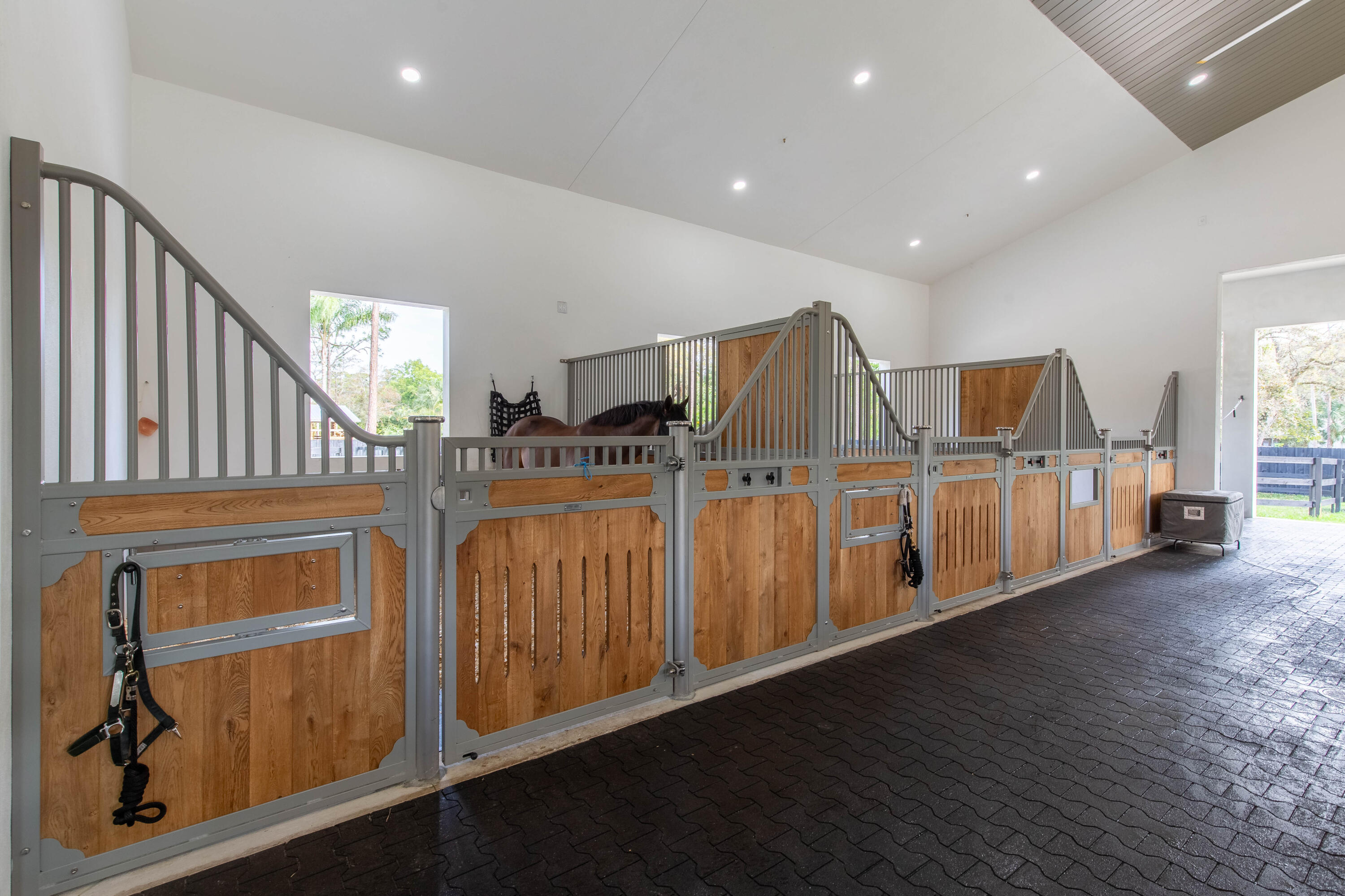 14717 Collecting Canal Road Loxahatchee Groves, FL 33470 - Photo 9 of 27 a view of a livingroom with furniture stairs wooden floor and windows