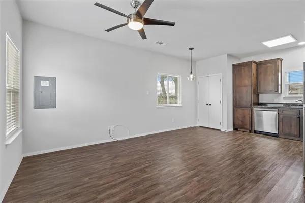 a view of a kitchen with wooden floor and a ceiling fan
