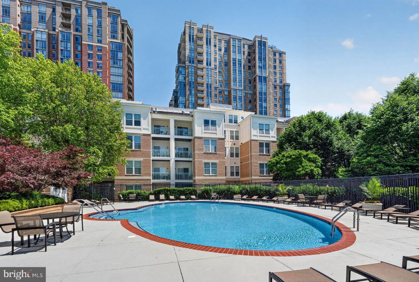 12000 Market Street, Unit 175 Reston, VA 20190 - Photo 24 of 27 a swimming pool with outdoor seating and yard