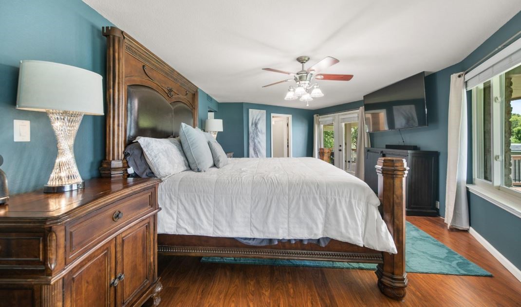 6714 Spray Lane, Unit C699A Rosharon, TX 77583 - Photo 14 of 48 2nd Floor Primary Owner's Suite features wood Flooring. Ceiling Fan & Stylish Paint Choice. Easy Access French Doors to 2md Floor deck & Heated LAP POOL.