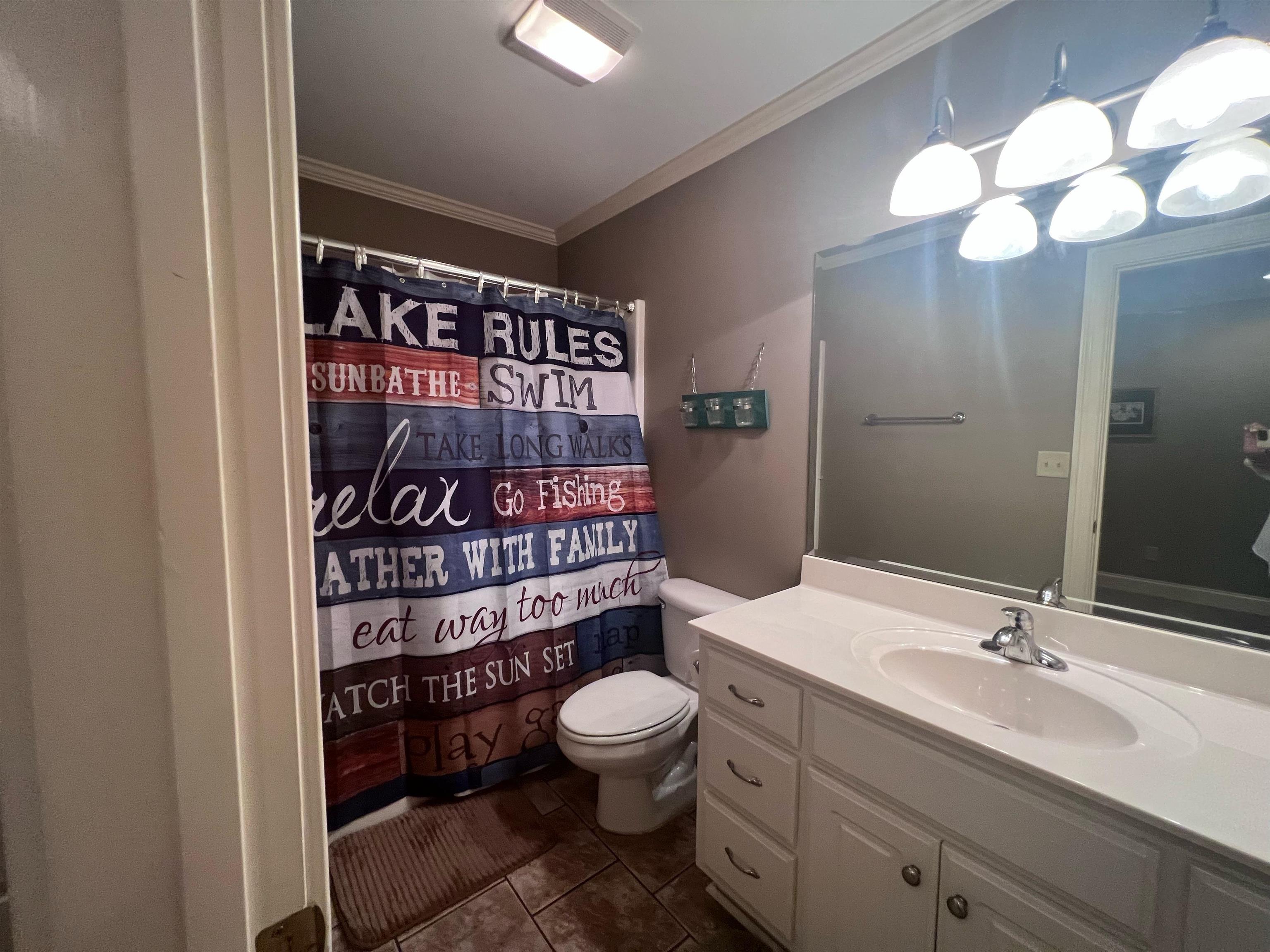 10 Patsy Path Iuka, MS 38852 - Photo 11 of 18 a bathroom with a toilet a sink and a mirror