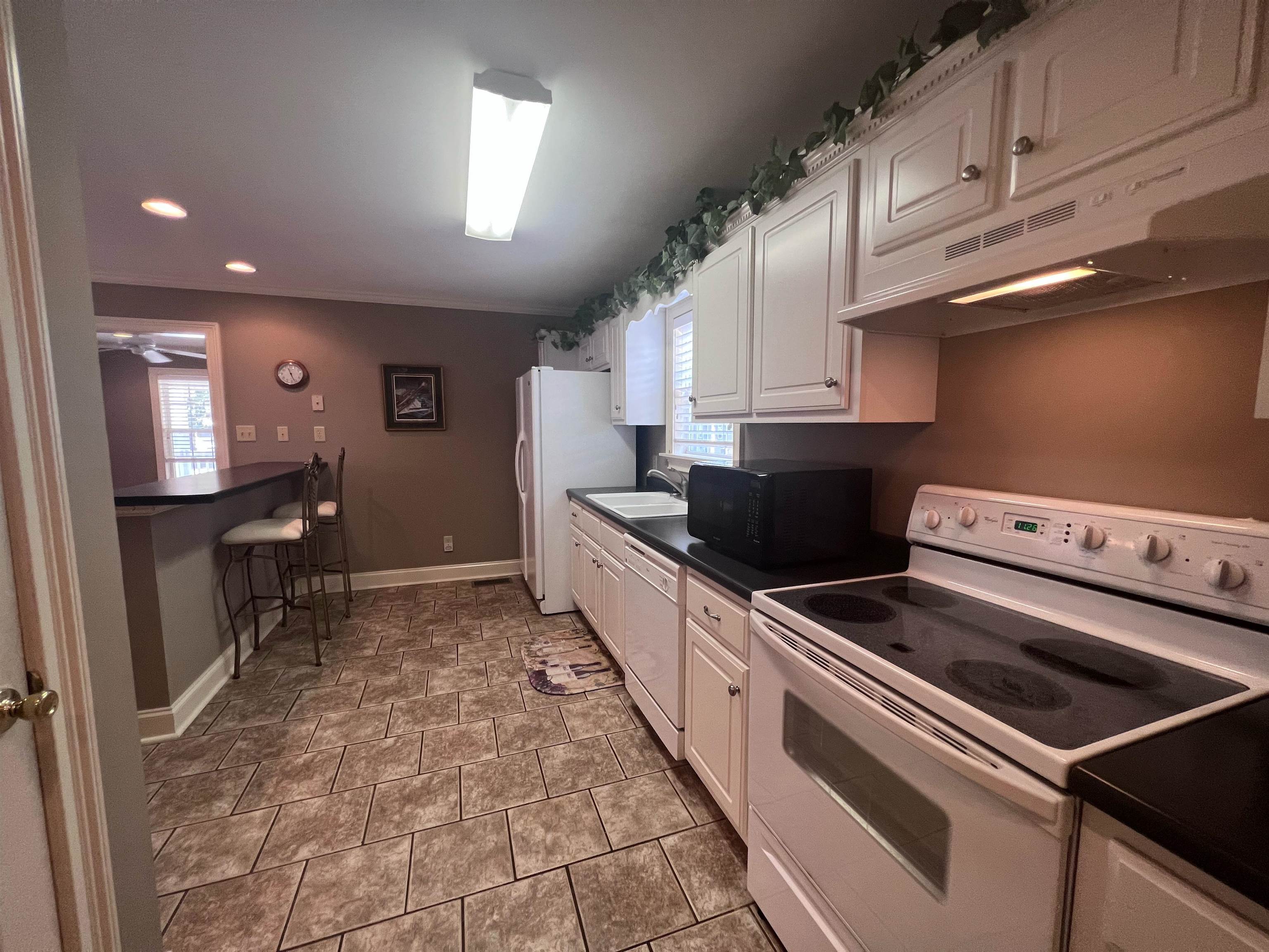10 Patsy Path Iuka, MS 38852 - Photo 8 of 18 a kitchen with granite countertop a stove sink and cabinets