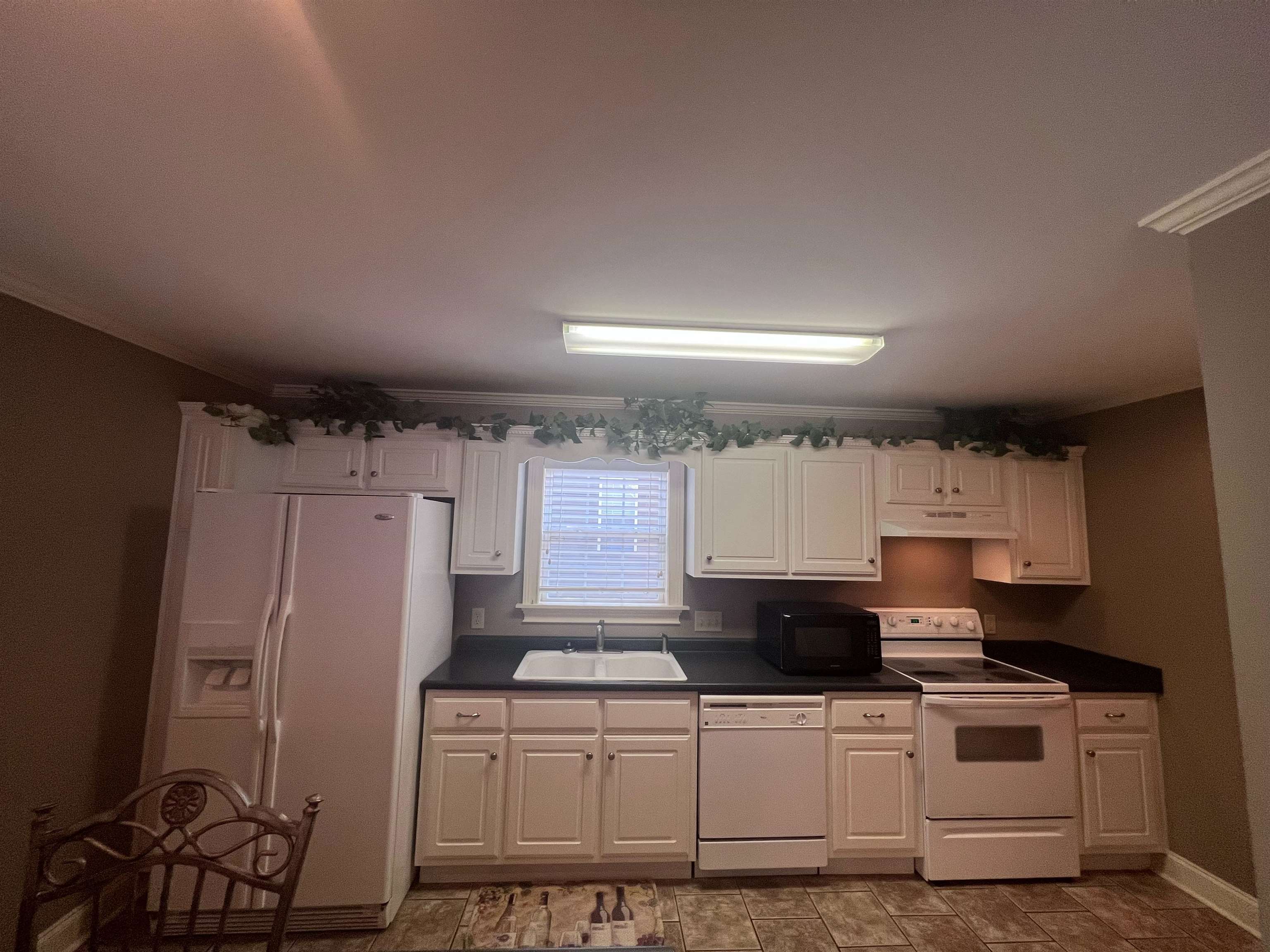 10 Patsy Path Iuka, MS 38852 - Photo 9 of 18 a kitchen with a refrigerator a stove top oven a sink and cabinets