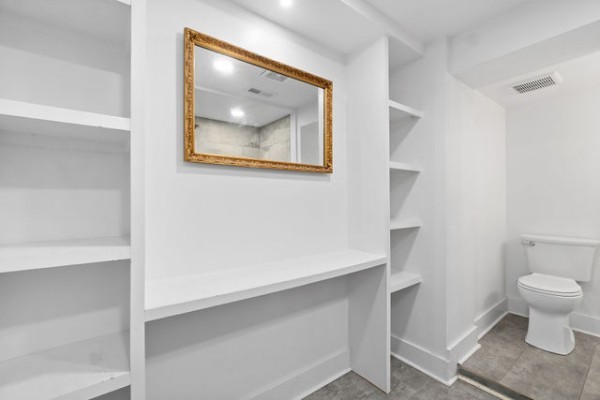276 East Porters Bluff Road Clarksville, TN 37040 - Photo 16 of 41 a view of a hallway with wooden floor and a toilet