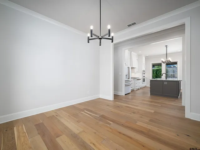 a view of a kitchen with wooden floor and a kitchen