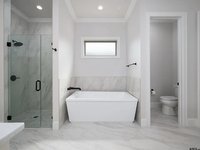a spacious bathroom with a bathtub and shower