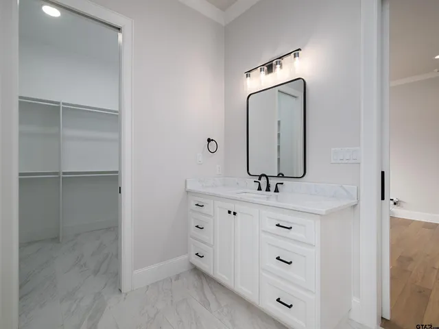 a bathroom with a double vanity sink mirror and