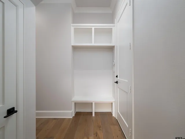 a view of walk in closet with empty racks