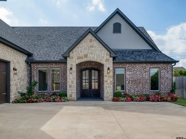 a front view of a house with yard and parking space