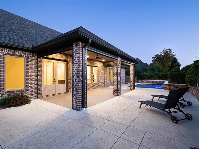 a swimming pool with outdoor seating and yard