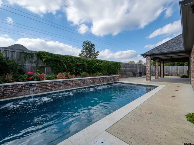 a view of a swimming pool with a patio