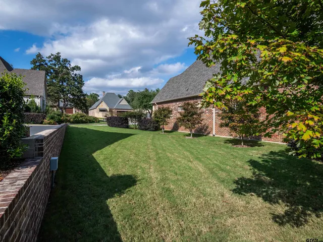 a view of a house with a wooden fence