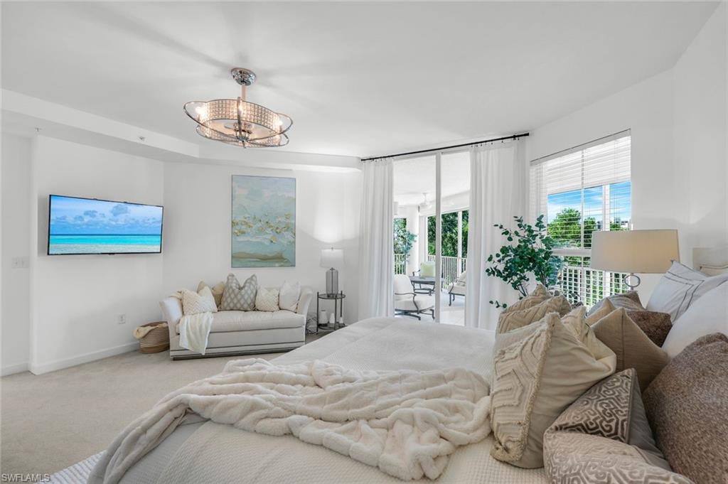 315 Dunes Boulevard, Unit 201 Naples, FL 34110 - Photo 11 of 30 a bedroom with furniture and a large window