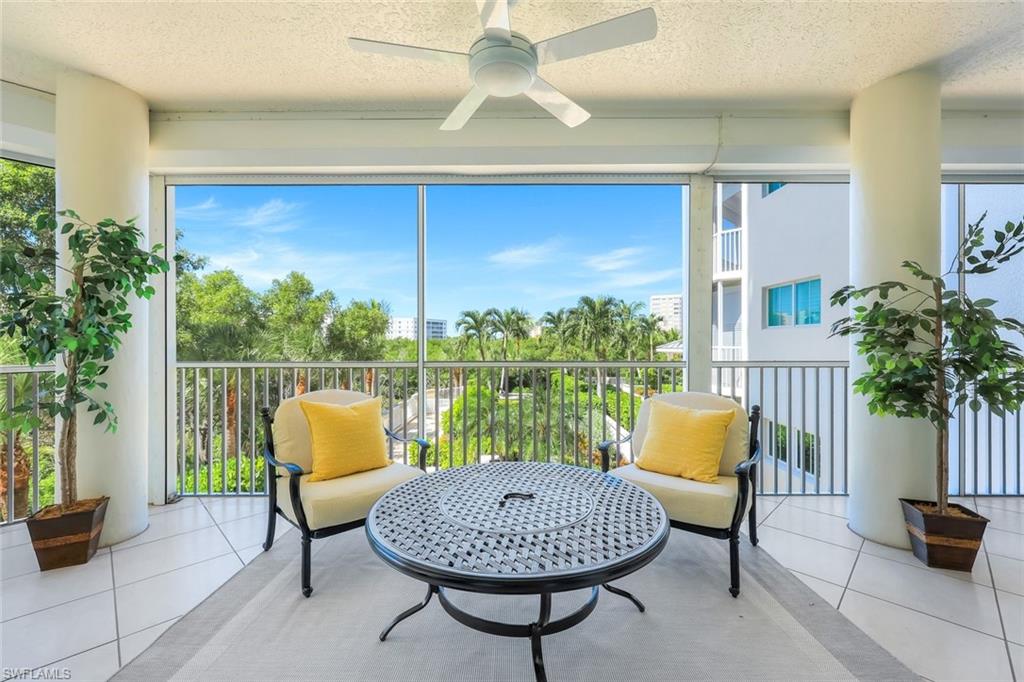 315 Dunes Boulevard, Unit 201 Naples, FL 34110 - Photo 18 of 30 a living room with patio furniture and a potted plant