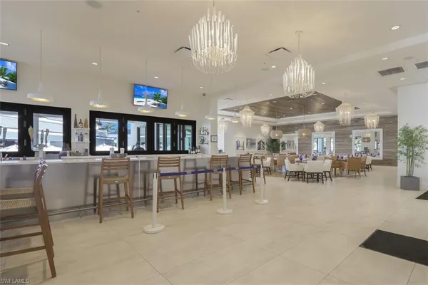 a view of a dining room with furniture and chandelier