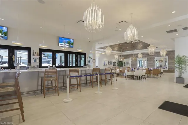 a view of a dining room with furniture and chandelier