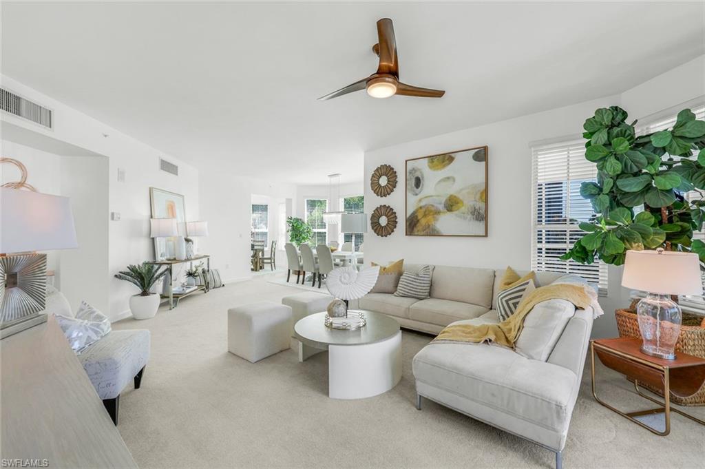 315 Dunes Boulevard, Unit 201 Naples, FL 34110 - Photo 7 of 30 a living room with furniture and a large window