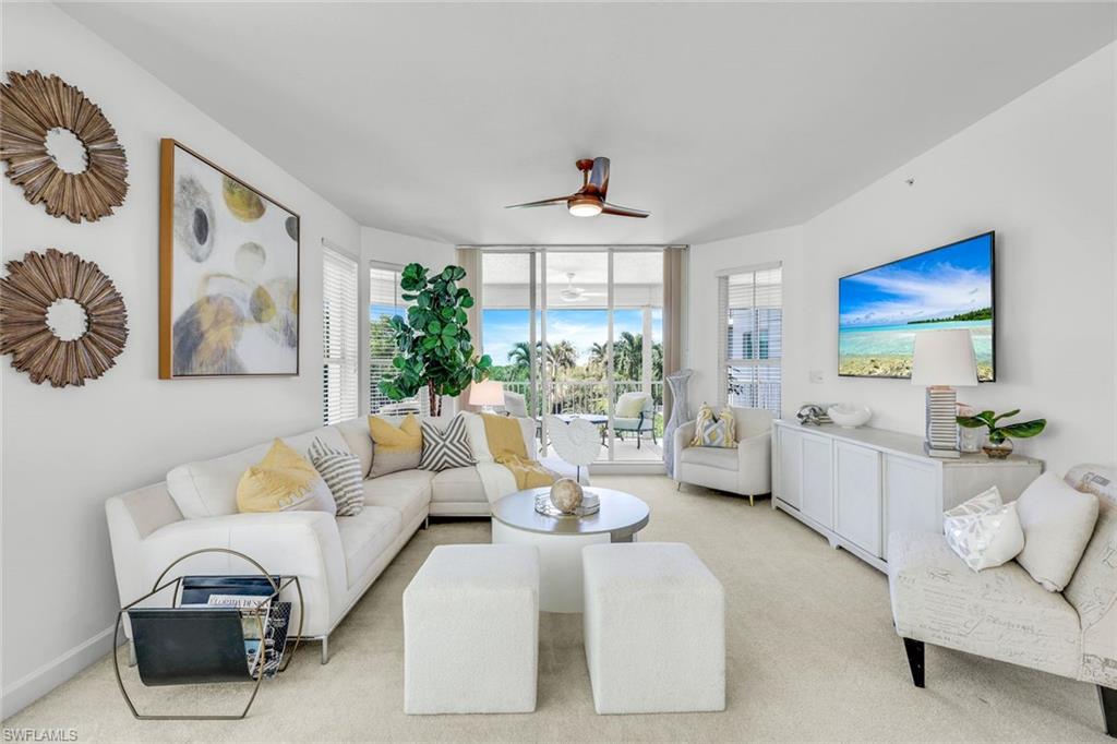 315 Dunes Boulevard, Unit 201 Naples, FL 34110 - Photo 8 of 30 a living room with furniture and a large window